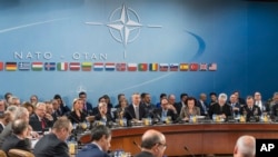 In this file photo, NATO defense ministers are seated during a meeting of the North Atlantic Council Defense Ministers session at NATO headquarters in Brussels, Oct. 27, 2016.