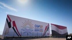The COP27 U.N. Climate Summit logo and the Egyptian flag are displayed on a billboard lining a newly constructed highway in Sharm el-Sheikh, Egypt, Nov. 5, 2022.