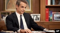 In this photo provided by the Greek Prime Minister's Office, Prime Minister Kyriakos Mitsotakis listens a question during an interview on Greece's Antenna TV, in Athens, Nov. 7, 2022.