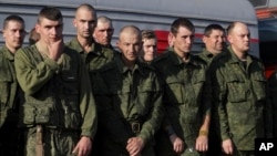 Russian recruits stand waiting to take a train at a railway station in Prudboi, Volgograd, region of Russia, September 29, 2022. 