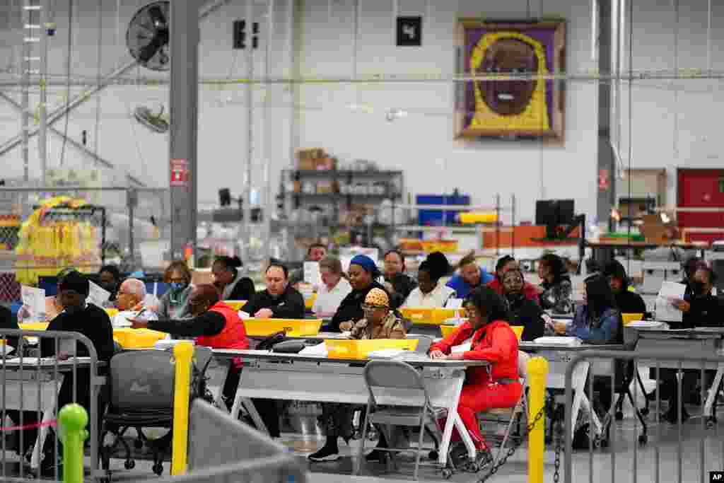 Election workers process mail-in-ballots for the midterm elections in Philadelphia, Pennsylvania, Nov. 8, 2022. 