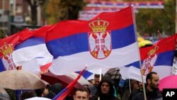 Kosovo Serbs wave Serbian flags in Mitrovica, Kosovo, on Nov. 6, 2022, as they protest Kosovo's decision to gradually ban Serbia-issued license plates. 