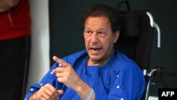 FILE - Pakistan's former prime minister Imran Khan addresses the media representatives at a hospital in Lahore, Nov. 4, 2022, a day after an assassination attempt on him.