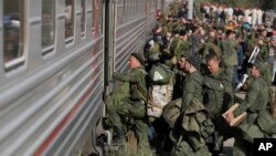FILE - Russian recruits board a train at a railway station in Prudboi, in Russia's Volgograd region, Sept. 29, 2022.