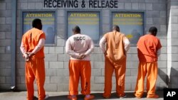 Prisoners from Sacramento County await processing after arriving at the Deuel Vocational Institution in Tracy, California, Feb. 20, 2014. 