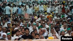 People attend a Maha Panchayat or grand village council meeting as part of a farmers' protest against farm laws in Muzaffarnagar in the northern state of Uttar Pradesh, India, Sept. 5, 2021.