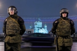 FILE - Interior Ministry officers stand guard during a rally in Bolotnaya Square, in Moscow, Dec. 10, 2011.