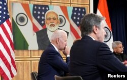 U.S. President Joe Biden, seated with Secretary of State Antony Blinken and India's Foreign Minister Subrahmanyam Jaishankar holds a videoconference with India's Prime Minister Narendra Modi to discuss Russia's war with Ukraine from the White House, Apr.