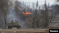 An armored vehicle of pro-Russian troops is seen in the street during Ukraine-Russia conflict in the southern port city of Mariupol, Ukraine, April 11, 2022.