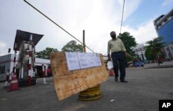 A Sri Lankan man walks past a shut down fuel station in Colombo, Sri Lanka, April 12, 2022.