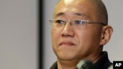FILE - Kenneth Bae, who had been held in North Korea since 2012, waits to talk to reporters at Joint Base Lewis-McChord, Washington, Nov. 8, 2014.