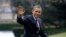  President Barack Obama waves following his arrival on Marine One helicopter from the House Democratic Issues Conference in Lansdowne, Virginia, as he walks across the South Lawn of the White House in Washington, February 7, 2013.