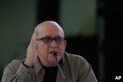 Antonio Garcia, of the Colombian guerrilla National Liberation Army (ELN), speaks to the press after signing an agreement with the Colombian government to resume peace talks, at the Casa Cultural Aquiles Nazoa in Caracas, Venezuela, Oct. 4, 2022.