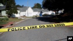 Sahalee Way in Raleigh, N.C., remains closed on Oct. 14, 2022, following a shooting the day before. Police say a 15-year-old boy fatally shot at least two people in a neighborhood, then fled toward a walking trail where he opened fire, killing and wounding others.
