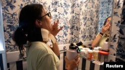 FILE - Lauren Nichols, who has long COVID, takes her second pill of the day of the low dose Naltrexone at her home in Andover, Massachusetts, U.S., August 3, 2022. (REUTERS/Lauren Owens Lambert/File Photo)