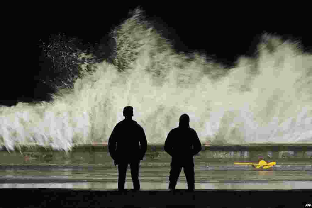People observe the waves hitting the Malecon in Havana, on Sept. 28, 2022, after the passage of Hurricane Ian. 