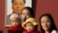 FILE - Two women and their babies pose for photographs in front of the giant portrait of late Chinese chairman Mao Zedong on the Tiananmen Gate in Beijing Nov. 2, 2015.