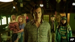 This image released by Netflix shows Adam Driver, center, in a scene from "White Noise." (Wilson Webb/Netflix via AP)