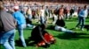 FILE - Stewards and supporters tend and care for wounded supporters on the field at Hillsborough Stadium, in Sheffield, England, April 15, 1989. 