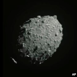 In this image made from a NASA livestream and taken from the Double Asteroid Redirection Test spacecraft, asteroid Dimorphos is seen as the spacecraft flies toward it, Monday, Sept. 26, 2022. (ASI/NASA via AP)