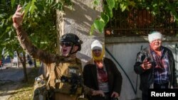 A paramedic helps people injured during a Russian missile strike in Kyiv, Ukraine Oct. 10, 2022.