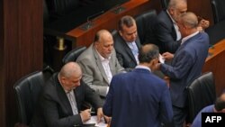 Clerks give voting ballots to members of the Lebanese Parliament during the 4th session to elect a new President in Beirut, Oct. 24, 2022. Lebanon failed for a fourth time to elect a successor to President Michel Aoun before his term ends next week. 