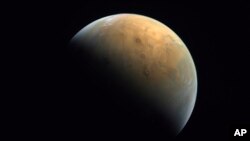 FILE - This image captured by the United Arab Emirates' "Amal" ("Hope") probe shows the planet Mars on Feb. 10, 2021. Ancient Mars may have had an environment capable of harboring an underground world teeming with microscopic organisms, French scientists reported Monday.