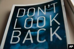 The cover of Achut Deng’s memoir, co-authored with Keely Hutton, is illustrated with the face of a girl overlaid by the night sky in Sioux Falls, South Dakota, Sept. 17, 2022.