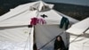 Ilustrasi - Seorang perempuan tua duduk di luar tenda pada 25 Februari 2016 di pusat relokasi untuk migran dan pengungsi di Schisto, dekat Athena.(LOUISA GOULIAMAKI / AFP)