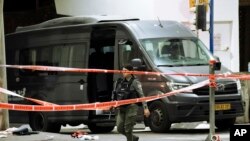 An Israeli border police officer walks at the scene of a shooting attack near the Shuafat refugee camp in Jerusalem, Oct. 8, 2022.