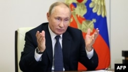 Russian President Vladimir Putin talks to participants of a video conference at the Novo-Ogaryovo state residence outside Moscow, Oct. 5, 2022. (Sputnik via AFP)