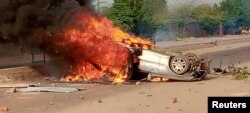 Smoke erupts from a vehicle set on fire during protests in N'Djamena, Chad, Oct. 20, 2022, in this picture obtained from social media. (Juda Allahondoum - Le Visionnaire/via Reuters)