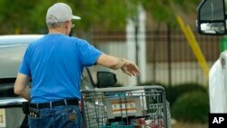 A shopper removes his purchases from his cart in Jackson, Miss., Oct. 12, 2022. Any Americans hoping for relief from months of punishing inflation might not see much in an upcoming government report on price increases in September.