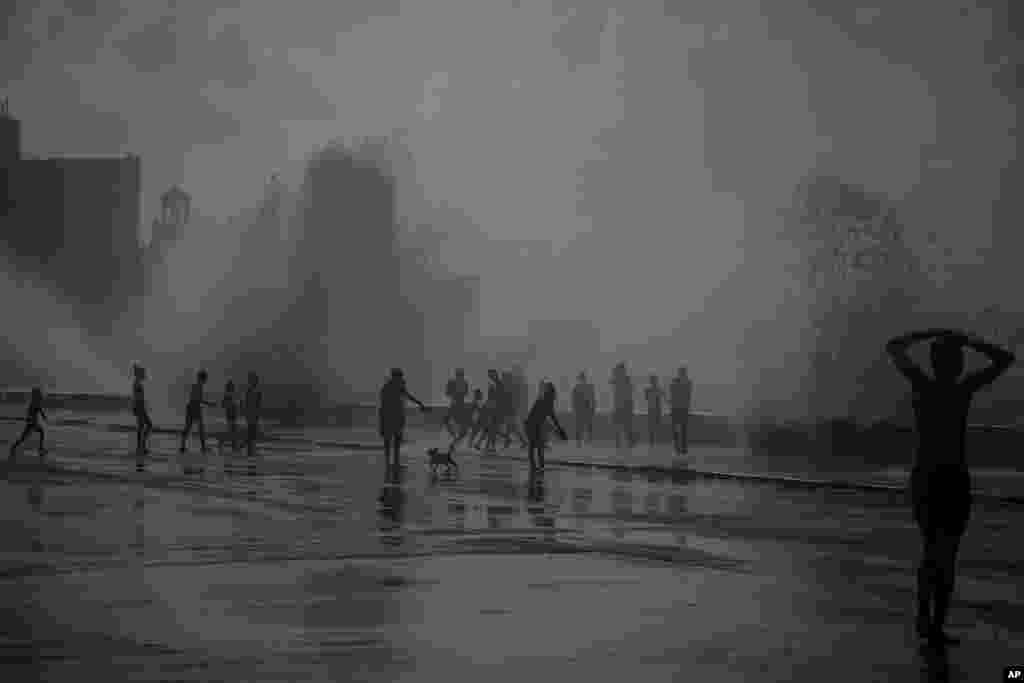 People play in the breaking waves at the Malecon, in the aftermath of Hurricane Ian in Havana, Cuba, Sept. 28, 2022.