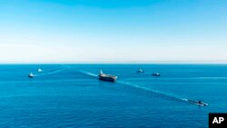 Kapal induk USS Ronald Reagan, tengah atas, berpartisipasi dalam latihan anti-kapal selam bersama antara Korea Selatan, Amerika Serikat dan Jepang di perairan lepas pantai timur Korea Selatan di Korea Selatan, Jumat, 30 September 2022 .(Foto: via AP)