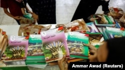 Distribution of unedited textbooks used to protest in East Jerusalem October 1, 2022. (REUTERS/Ammar Awad
)