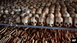 FILE - The skulls and bones of some of those who were slaughtered as they sought refuge inside a church are laid out as a memorial to the thousands who were killed in and around a Catholic church during the 1994 genocide in Ntarama, April 4, 2014. 