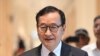 FILE - Cambodian opponent in exile and leader of the Cambodia National Rescue Party (CNRP) Sam Rainsy, speaks to the press as he arrives at the court house accused in a defamation lawsuit filed by Cambodia's prime minister, in Paris on September 1, 2022.