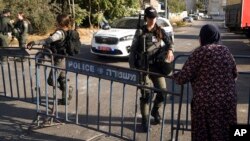 A Palestinian woman talks with an Israeli Border Police officer at a demonstration by liberal Israelis against overnight clashes between Palestinian residents and Israeli settlers in the embattled Sheikh Jarrah neighborhood of east Jerusalem, Oct. 14, 202