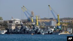FILE - Russian Black Sea fleet ships are seen in one of the bays of Sevastopol, in Russia-annexed Crimea, March 31, 2014. On Oct. 29, 2022, at two Russian ships in Sevastopol's port suffered damage in an attack Russia is using to justify its suspension of the grain export deal.