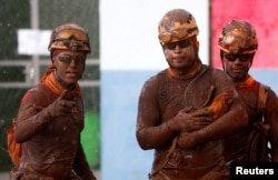 A member of a rescue team carries a rooster after a tailings dam owned by Brazilian mining company Vale SA collapsed, in Brumadinho, Brazil, Jan. 30, 2019.