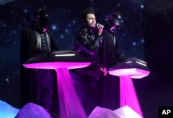 The Weeknd, center, and Daft Punk perform at the 59th annual Grammy Awards, Feb. 12, 2017.