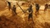 Artisanal miners dig for gold in an open-pit concession near Dunkwa, western Ghana, February 15, 2011. 