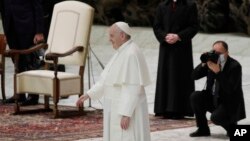 Pope Francis waves to faithful in the Paul VI hall at the end of his weekly general audience at the Vatican, Wednesday, Oct. 21, 2020. Pope Francis endorsed same-sex civil unions for the first time as pope in a documentary. (AP Photo/Gregorio Borgia)