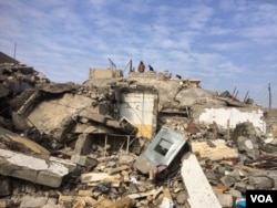 Families sift through the destruction as many homes, hospitals and other buildings were destroyed by Islamic State or in the fighting over the past four months in Mosul, Iraq, Jan. 30, 2017. (H. Murdock/VOA)