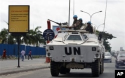 FILE - U.N. peacekeepers drive in a armored personnel carrier, in Abidjan, Ivory Coast, March 1, 2011.