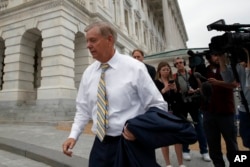 Sen. Lindsey Graham, R-S.C., departs Capitol Hill, Oct. 6, 2018, in Washington.