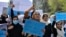 FILE - Afghan women and girls shout slogans demanding the reopening of high schools for girls during a demonstration in front of the Ministry of Education in Kabul, March 26, 2022.