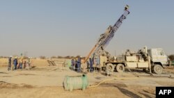 Des ouvriers du bâtiment locaux travaillent à la construction sur un pipeline de remplissage de camions en Afrique du Sud.