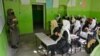 FILE - Girls attend a class at their school in Kabul, March 23, 2022. The Taliban prohibition on girls' education shows ultra-conservatives retain control of the Islamist group and exposes a power struggle putting at risk crucial aid for Afghanistan's desperate population.